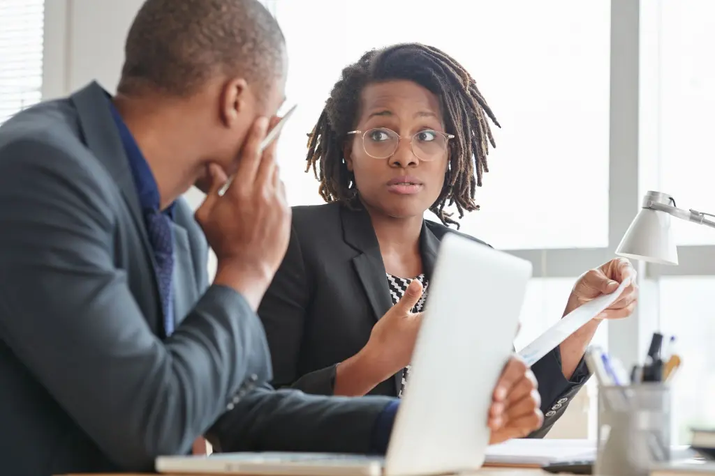 afro-american-male-female-colleagues-suits-talking-office (1).webp